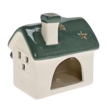 Porcelánový domček na sviečku v bielej a zelenej farbe.