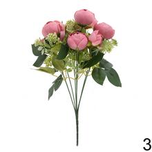 Kytica ranunculus s drobnými kvetmi a zeleňou v mixe.