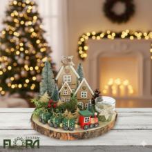 Vianočné aranžmá s drevenými domčekmi a vláčikom.