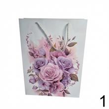 Darčeková taška s kvetinovým vzorom a trblietkami.