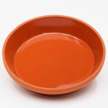 Glazovaná miska o průměru 9 cm v oranžové barvě.