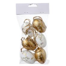 Sada plastových vajíček se vzorem květin v zlaté a bílé barvě.