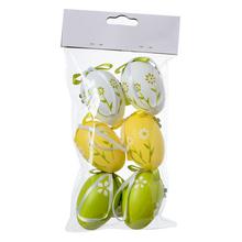 Sada plastových vajíček v bílé, žluté a zelené barvě s květinovým vzorem.