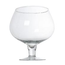 Skleněný pohár s hladkým povrchem a širokým okrajem.