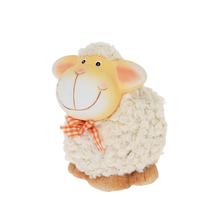 Ovečka s usměvavou tváří a oranžovou mašlí.