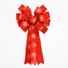 Červená a zlatá mašle na vánoční dárky.