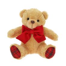 Sedící medvěd s hnědým kožíškem a červenou mašlí.